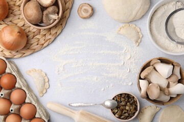 Process of making dumplings (varenyky) with mushrooms. Frame made of ingredients on white table,...
