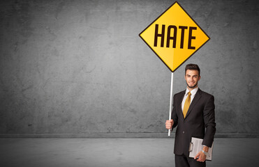 Young business person holding road sign