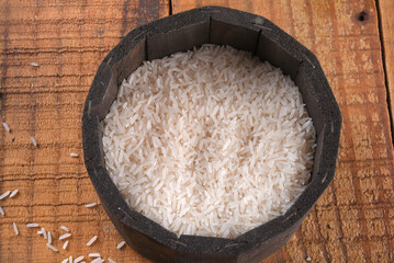 white rice natural long rice grain uncooked healthy food wooden table use texture background