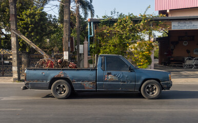 The pick up drives an agricultural machine, Thailand