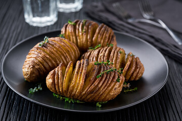 Traditional Swedish recipe delicious baked potatoes with herbs and oil, Hasselback potato.