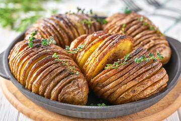 Delicious baked potatoes with herbs and oil. Swedish cuisine. Potatoes dish from Sweden.