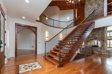 grand entrance foyer with staircase and fireplace - Powered by Adobe