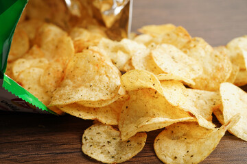 Potato chips in open bag, delicious BBQ seasoning spicy for crips, thin slice deep fried snack fast food in open bag.