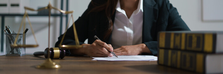 Businesswoman lawyer reading agreement business to signing on contract and working in legal office
