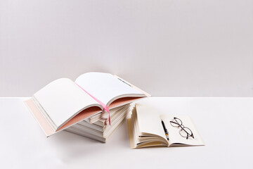 Stack of books with glasses on white background. Back to school concept.