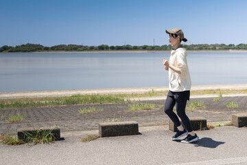 河川敷をジョギングする女性