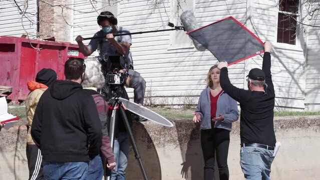 Behind the scenes of a news reporter talking to a professional camera, film set