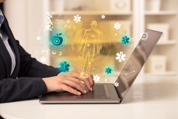 Doctor working on laptop with healthcare concept