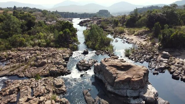 Flying Above Scenic River Flowing Through Rocks In The Drakensberg Mountains In South Africa. aerial