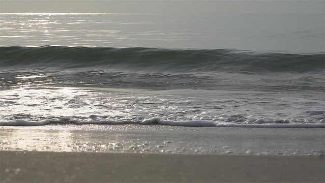 Slow Motion Shot Of Ocean Waves Crashing On Sandy Beach