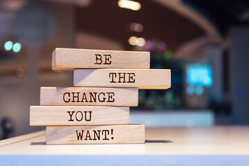 Wooden blocks with words 'Be the change you want'.