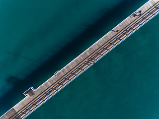 Aerial view of Busselton Jetty wharf. Sunny day in summer with clear water. Travel to Busselton, Western Australia. Top view. Coastal, Seascape