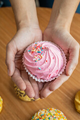 Traditional gourmet dessert in the hand of a person, typical Latin American food in studio, sweets as wallpaper, pastry textures
