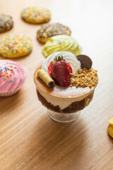 delicious ice cream decorated with chocolate, topping and strawberry in the background homemade cookies, dessert as wallpaper