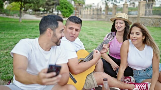 Group of people make selfie by smartphone having picnic at park