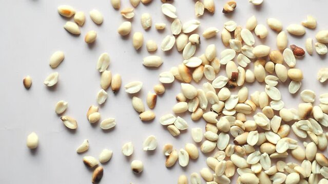 slow motion of throwing peanuts on white background 
