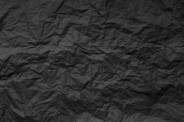 Natural abstract textured background of wrinkled black paper.