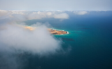 Cabo Verde. Aerial view of Sal Island from the middle of Atlantic Ocean, an amazing beach resort, during a sunny day with blue sky and turquoise blue water color.
