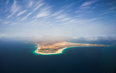 Cabo Verde. Aerial view of Sal Island from the middle of Atlantic Ocean, an amazing beach resort, during a sunny day with blue sky and turquoise blue water color. - obrazy, fototapety, plakaty