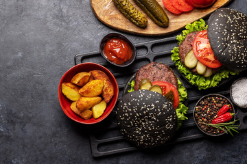 Homemade beef burgers with black buns