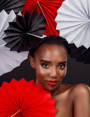 Portrait, makeup and black woman with origami fans, beauty and confident girl against black...
