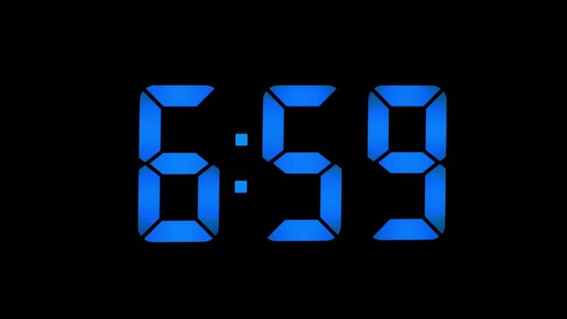 LED clock close-up, shows 7-00 am, the concept of the beginning of the working day, blue seven-segment numbers