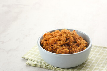 Abon Sapi, dried shredded beef or beef floss, served in bowl.
