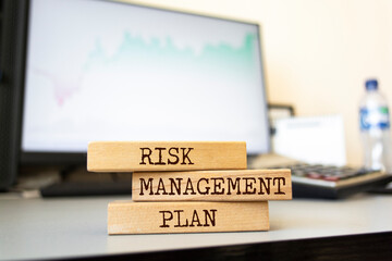 Wooden blocks with words 'Risk Management Plan'.