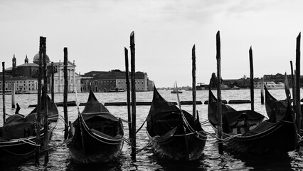 Gondolas moored by Saint Mark square with San Giorgio di Maggiore church in Venice, Italy