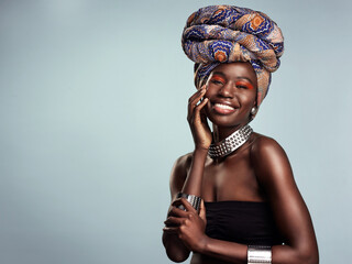 Smile, black woman and portrait with African head wrap and beauty in a studio. Isolated, grey background traditional Africa turban with a young face and female model with culture pride and mockup