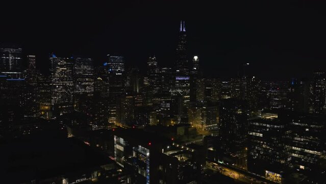 Aerial view around the illuminated skyline of downtown Chicago, night in USA