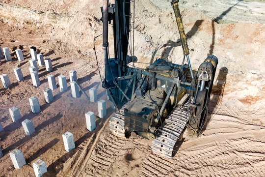 Pile driving machine. Diesel hammer pile driving machine working on construction site. Preparation of the pile foundation for the construction of the building.