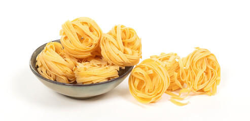 Tagliatelle pasta rolls on white background