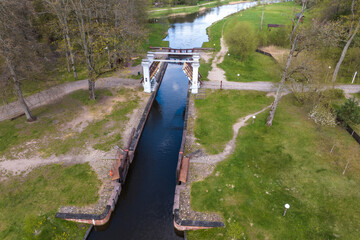 Fototapeta premium aerial view over dam lock sluice on lake impetuous waterfall