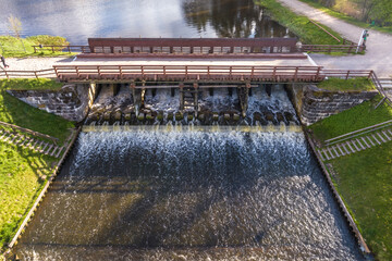 aerial view over dam lock sluice on lake impetuous waterfall