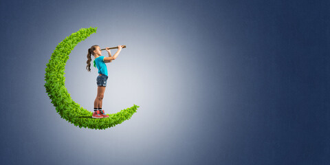 Concept of careless happy childhood with girl on green moon