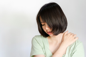 Fototapeta premium Woman showing pain in shoulder because of muscle inflammation.
