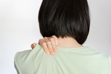 Woman showing pain in shoulder because of muscle inflammation.