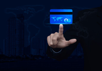 Businessman pressing credit card over world map, modern city tower and skyscraper, Online e-payment concept, Elements of this image furnished by NASA
