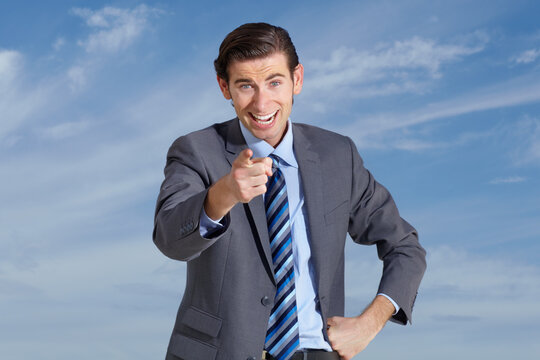 Portrait, happy business man and pointing finger to you on cloudy blue sky for vote, winner and offer. Face of corporate employee, smile and gesture forward for hand direction, emoji and decision
