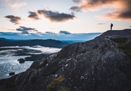 one hiker stands on summit of Borestone Mountain, Maine