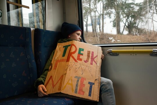 boy on a train on his way to strike for climate change in Stockholm