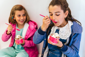 two little girls eating ice cream