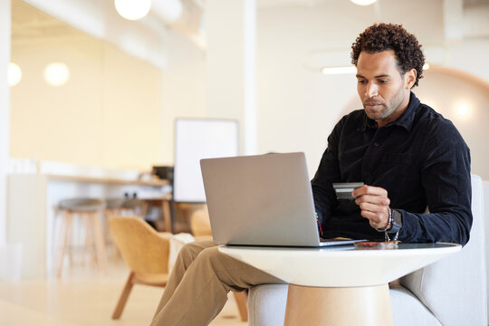 Businessman doing online shopping through laptop and credit card