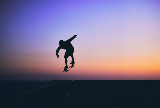 Skateboarder in action, silhouette unrecognizable.