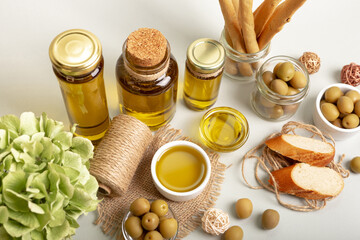 Green whole olives and extra virgin olive oil in rustic style.