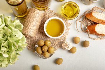 Green whole olives and extra virgin olive oil in rustic style.