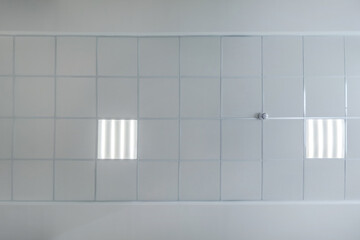 cassette stretched or suspended ceiling with square halogen spots lamps and drywall construction in...