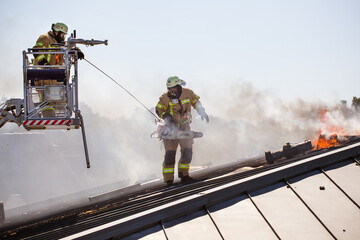 Berlin firefighters fight a fire in a roof truss